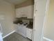 Compact kitchen with white appliances, granite countertop, and wood cabinetry at 2516 E Mesquite Ave, Las Vegas, NV 89101
