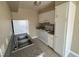 Compact kitchen with white appliances, granite countertop, double basin sink and wood cabinetry at 2516 E Mesquite Ave, Las Vegas, NV 89101