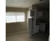 Kitchen corner with white cabinets, a window, and tile flooring at 2516 E Mesquite Ave, Las Vegas, NV 89101