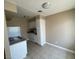 Compact eat-in kitchen with white appliances, granite countertop, and tile flooring at 2516 E Mesquite Ave, Las Vegas, NV 89101