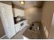 This is a view of a kitchen that features white cabinetry, granite countertops, and stainless appliances at 2516 E Mesquite Ave, Las Vegas, NV 89101