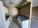 This is a view of a kitchen that features white cabinetry, granite countertops, and stainless appliances at 2516 E Mesquite Ave, Las Vegas, NV 89101