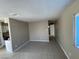 Open floor plan living room with tile flooring, and access to a kitchen area at 2516 E Mesquite Ave, Las Vegas, NV 89101