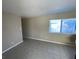 Living room with neutral walls and tile flooring, featuring a window with natural light at 2516 E Mesquite Ave, Las Vegas, NV 89101