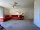 Cozy living room with neutral carpeting and bright red sofa at 2606 S Durango Dr # 263, Las Vegas, NV 89117