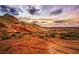 Image of scenic desert landscape with red rock formations and vegetation at 7108 Silver Palace St, Las Vegas, NV 89131