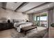 Spacious primary bedroom with an attached balcony and mountain views at 7133 Serene Creek St, Las Vegas, NV 89131