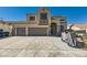 Two-story house with a three-car garage, landscaping, and Halloween decorations at 537 Viva Serenade Way, Henderson, NV 89015