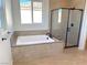 Bathroom with soaking tub, walk-in shower, and modern vanity at 6349 Laverick Dr, North Las Vegas, NV 89081