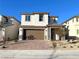 Two story house with brown garage door and stone accents at 6349 Laverick Dr, North Las Vegas, NV 89081