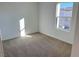 Well-lit bedroom with neutral carpet and large window at 6353 Laverick Dr, North Las Vegas, NV 89081