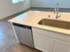 Modern kitchen island with stainless steel dishwasher and quartz countertop at 6353 Laverick Dr, North Las Vegas, NV 89081