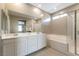Bathroom featuring double sinks, a soaking tub, and a glass-enclosed shower at 1438 Dire Wolf Ave, North Las Vegas, NV 89084