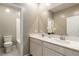 Elegant bathroom featuring double sinks, a large mirror, and a separate toilet for convenience at 1438 Dire Wolf Ave, North Las Vegas, NV 89084