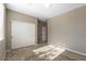 Spacious bedroom with a large closet and carpeted floors, bathed in natural light from the window at 1438 Dire Wolf Ave, North Las Vegas, NV 89084