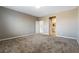 Large carpeted bedroom with multiple doors and neutral wall color at 1438 Dire Wolf Ave, North Las Vegas, NV 89084