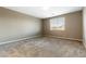 Spacious carpeted bedroom with a large window and ample natural light at 1438 Dire Wolf Ave, North Las Vegas, NV 89084