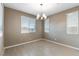 Cozy dining area with a stylish chandelier, large windows, and neutral walls for a bright, inviting atmosphere at 1438 Dire Wolf Ave, North Las Vegas, NV 89084