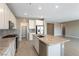 Well-equipped kitchen with stainless steel appliances, granite counters, an island, and a walk-in pantry for ample storage at 1438 Dire Wolf Ave, North Las Vegas, NV 89084