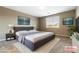 Stylish main bedroom with modern decor, plush rug, and a king-size bed, ideal for comfort at 1438 Dire Wolf Ave, North Las Vegas, NV 89084