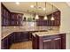 Community bar with dark wood cabinets and granite countertops at 20 Via Visione # 105, Henderson, NV 89011