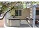 Outdoor kitchen with stainless grill, sink, and countertop bar area under covered patio at 2138 Fort Halifax St, Henderson, NV 89052