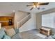 Living room with teal couch and staircase view at 4750 Newby Hall Ct, Las Vegas, NV 89130