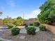 Landscaped backyard with fire pit and circular patio at 6423 Fosco Ct, Las Vegas, NV 89131
