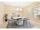 Virtually staged dining room with a chandelier and modern dining set at 6423 Fosco Ct, Las Vegas, NV 89131