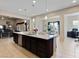 Open kitchen with large island, stainless steel appliances and view into Gathering room at 6423 Fosco Ct, Las Vegas, NV 89131