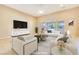 Virtually staged living room featuring modern furniture and a large TV at 6423 Fosco Ct, Las Vegas, NV 89131