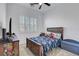 Cozy bedroom with a rustic wooden bed frame and camouflage bedding at 829 Stepney Pl, Henderson, NV 89011