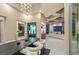 Open concept dining room with modern chandelier and views to living room at 1228 Stellar Rim Ct, Henderson, NV 89012