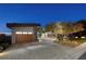 Modern home with wood garage door and landscaped yard at 1228 Stellar Rim Ct, Henderson, NV 89012