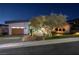 Modern home with wood garage door and landscaped yard at 1228 Stellar Rim Ct, Henderson, NV 89012
