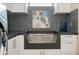 Modern laundry room with concrete sink, updated washer and dryer, and mosaic art at 1228 Stellar Rim Ct, Henderson, NV 89012