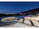 Infinity pool with a fire pit and stunning city views at night at 1228 Stellar Rim Ct, Henderson, NV 89012