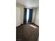 Cozy bedroom with dark carpet, neutral walls, and a window providing natural light at 2509 Canosa Ave, Las Vegas, NV 89104