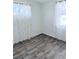 Bedroom featuring wood-look flooring and bright natural light from the windows at 2509 Canosa Ave, Las Vegas, NV 89104
