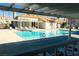 Community pool and lounge area with covered pergola at 3125 N Buffalo Dr # 1089, Las Vegas, NV 89128