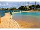 Relaxing community pool with sandy beach entry and lake access at 3125 N Buffalo Dr # 1089, Las Vegas, NV 89128