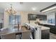 Elegant dining area featuring a chandelier and breakfast bar, enhancing the kitchen's charm at 3125 N Buffalo Dr # 1089, Las Vegas, NV 89128