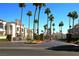 Community entrance with towering palm trees and manicured landscaping at 3125 N Buffalo Dr # 1089, Las Vegas, NV 89128