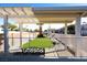 Community green space with synthetic turf and lounge bench under a trellis at 3125 N Buffalo Dr # 1089, Las Vegas, NV 89128
