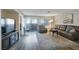 Spacious living room with comfortable seating, television, and access to a balcony at 3125 N Buffalo Dr # 1089, Las Vegas, NV 89128