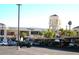 Exterior view of a shopping center featuring a variety of shops and businesses with ample parking at 3125 N Buffalo Dr # 1089, Las Vegas, NV 89128