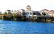 Waterfront building featuring large windows and lush landscaping, with tranquil water views, reflecting architectural beauty at 3125 N Buffalo Dr # 1089, Las Vegas, NV 89128