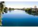 Serene waterfront view of community, enhanced by the clear blue water and lush landscaping, creating a peaceful ambiance at 3125 N Buffalo Dr # 1089, Las Vegas, NV 89128