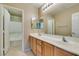 Bathroom with double vanity and light wood cabinets at 26 Drawback St, Henderson, NV 89012