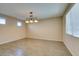 Dining room with wood-look tile floors and a three-light chandelier at 26 Drawback St, Henderson, NV 89012